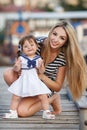 Happy young mother with a young daughter near Yacht Club Royalty Free Stock Photo