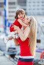 Happy young mother with a young daughter near Yacht Club Royalty Free Stock Photo