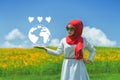 Happy young muslim woman hand showing Love earth.