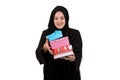 Happy young muslim woman with shopping bag and gift boxes isolated over white background Royalty Free Stock Photo