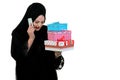 Happy young muslim woman with shopping bag and gift boxes isolated over white background Royalty Free Stock Photo