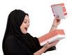 Happy young muslim woman with shopping bag and gift boxes isolated over white background Royalty Free Stock Photo