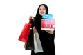 Happy young muslim woman with shopping bag and gift boxes isolated over white background Royalty Free Stock Photo