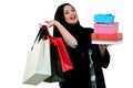 Happy young muslim woman with shopping bag and gift boxes isolated over white background Royalty Free Stock Photo