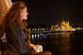 Happy young natural woman wondering in Budapest night panorama Royalty Free Stock Photo