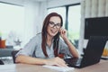 Happy young nerd woman learning to exams indoors Royalty Free Stock Photo