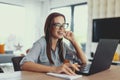 Happy young nerd university student laughing at laptop Royalty Free Stock Photo