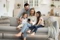 Smiling parents with children using cellphone at home Royalty Free Stock Photo