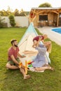 Mother and father camping with their baby boy by the swimming pool Royalty Free Stock Photo