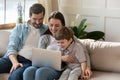 Happy young parents with little son using laptop together Royalty Free Stock Photo