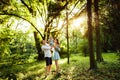 Happy young parents with lovely baby girl walking at the park, loving parents hold little daughter in caring arms Royalty Free Stock Photo