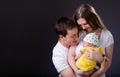 Happy young parents and newborn girl