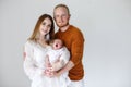 Happy young parents with a newborn son in their arms in the Studio on a white background. Royalty Free Stock Photo