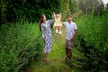 Happy young parents playing with their little baby girl at the green garden Royalty Free Stock Photo