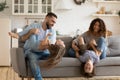 Happy young parents playing with two little kids at home Royalty Free Stock Photo