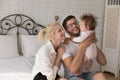 Happy young parents spend time with baby at home