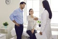 Happy young patients thanking their family doctor for good consultation and medical help Royalty Free Stock Photo