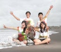 Happy young people in a beach in summer with slow motion and blurry concept