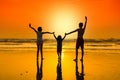 Happy young people dancing at the beach on sunset. Royalty Free Stock Photo