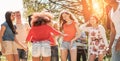 Happy young people dancing in forest party in summer time - Diverse culture friends having fun in music festival - New generation Royalty Free Stock Photo