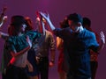 Happy young people dancing in night club Royalty Free Stock Photo