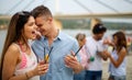 Happy young people, friends having fun on the beach and drinking cocktails together. Royalty Free Stock Photo