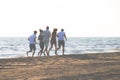 Happy young people group have fun white running and jumping on beach at sunset time Royalty Free Stock Photo