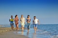 Happy young people group have fun white running and jumping on beacz at sunset time Royalty Free Stock Photo