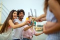 Happy young people, friends having fun on the beach and drinking cocktails together. Royalty Free Stock Photo