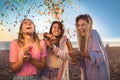 Young people having fun at beach party, celebrating with confetti Royalty Free Stock Photo