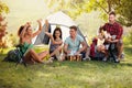 Happy young people having fun with music on camping trip Royalty Free Stock Photo