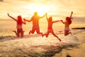 happy young people jumping on the beach Royalty Free Stock Photo