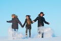 Happy young people running winter outdoors Royalty Free Stock Photo