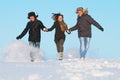 Happy young people running winter outdoors Royalty Free Stock Photo