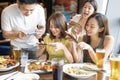 Happy young people taking  picture with smart phone in restaurant Royalty Free Stock Photo