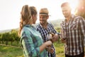 People tasting wine in vineyard