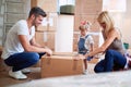 Young people unpacking cardboard boxes in their new home Royalty Free Stock Photo