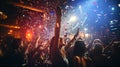 Happy young people through up confetti at night club party. Friendship, happiness, celebration, togetherness idea