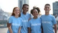 Happy young people volunteer t-shirts posing camera, social teamwork, help