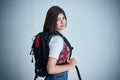 Happy young positive student posing over bright background