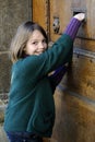 Happy young postman waiting on museum door