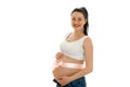 Happy young pregnant brunette woman with pink tape on her belly looking and smiling on camera isolated on white Royalty Free Stock Photo