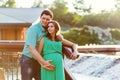 Happy and young pregnant couple hugging in nature Royalty Free Stock Photo