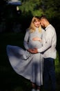 Happy and young pregnant couple hugging outdoor Royalty Free Stock Photo