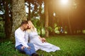 Happy and young pregnant couple hugging outdoor