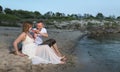 Happy young pregnant couple relaxing on beach Royalty Free Stock Photo