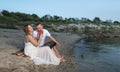 Happy young pregnant couple relaxing on beach Royalty Free Stock Photo