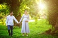 Happy and young pregnant couple walking outdoor Royalty Free Stock Photo