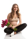 Happy young pregnant woman holding flowers Royalty Free Stock Photo