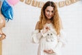 Happy young pregnant woman holding small baby shoes Royalty Free Stock Photo